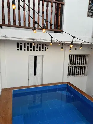 a swimming pool with a blue floor in a building at Art House Getsemaní in Cartagena de Indias
