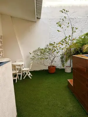 a patio with green grass and a table and chairs at Art House Getsemaní in Cartagena de Indias