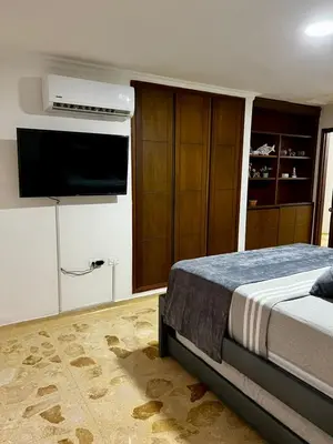 a bedroom with a bed and a flat screen tv at Apartamento en Manga in Cartagena de Indias