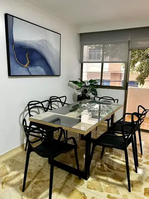 a dining room with a glass table and chairs at Apartamento en Manga in Cartagena de Indias