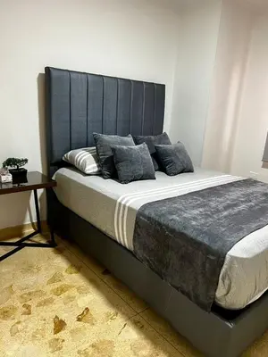 a large bed with a blue headboard in a room at Apartamento en Manga in Cartagena de Indias