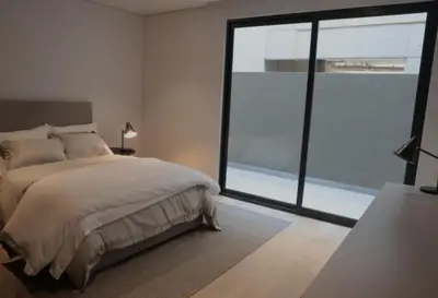 a bedroom with a large bed and a large window at Hotel El Confort in San Juan Nepomuceno
