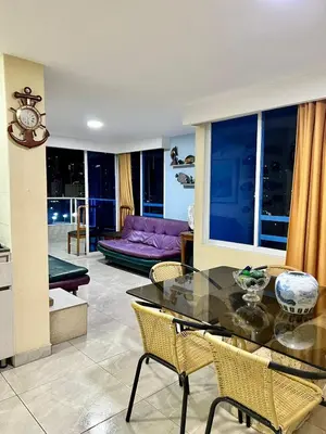 a living room with a glass table and chairs at Apartamentos Por dias Laguito Ctg in Cartagena de Indias