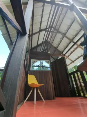 a yellow chair sitting in the middle of a room at Lala's Place in Isla Fuerte