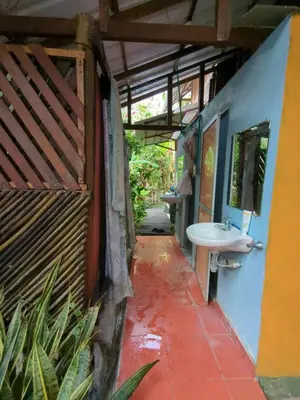 an outdoor bathroom with a sink and a sink at Lala's Place in Isla Fuerte