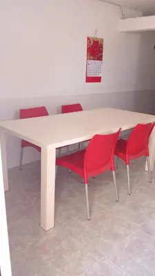 a white table with four red chairs around it at Le Petit Apartamento Con Encanto En Cartagena in Cartagena de Indias