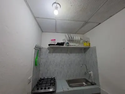 a small kitchen with a stove and a sink at Le Petit Apartamento Con Encanto En Cartagena in Cartagena de Indias