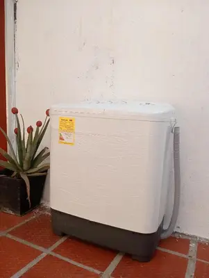 a white refrigerator sitting on the floor next to a wall at Le Petit Apartamento Con Encanto En Cartagena in Cartagena de Indias