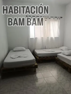 two beds in a room with the words mitigation ban ban at Casa yamulemao in Cartagena de Indias