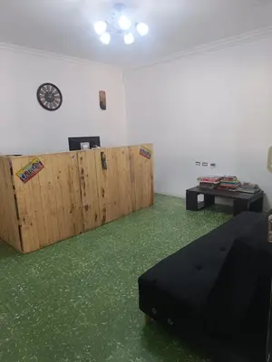 a living room with green flooring and wooden doors at Casa yamulemao in Cartagena de Indias