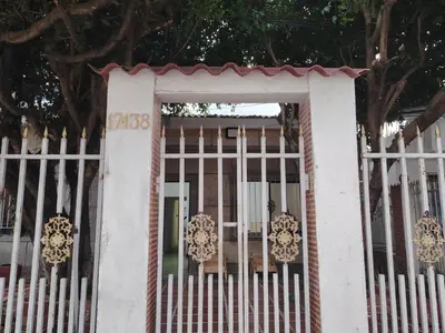 a white fence with a gate in front of a house at Casa yamulemao in Cartagena de Indias