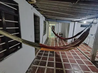 a hammock hanging from a wall in a room at Casa yamulemao in Cartagena de Indias