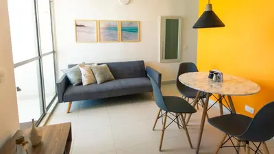 a living room with a couch and a table at Apartamento Oasis Cartagena in Cartagena de Indias