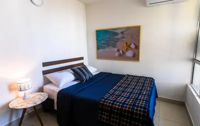 a bedroom with a bed and a couch in it at Apartamento Oasis Cartagena in Cartagena de Indias