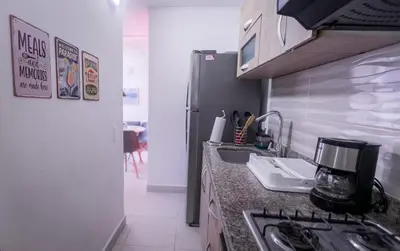 a kitchen with a sink and a stove top oven at Apartamento Oasis Cartagena in Cartagena de Indias