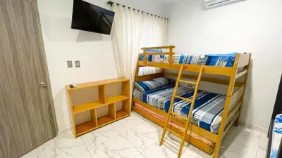 a bedroom with two bunk beds and a television at Casa Elena in Tolú