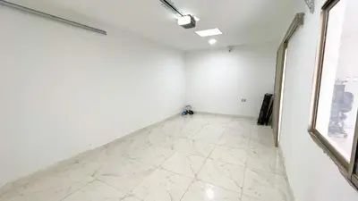 an empty room with white walls and a white tile floor at Casa Elena in Tolú