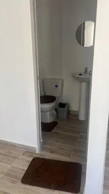 a bathroom with a toilet and a sink at Margarita's apt in Barranquilla