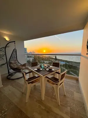 a dining room with a table and a view of the ocean at CB1108 | Sunset Suite con Frente al Mar in Cartagena de Indias