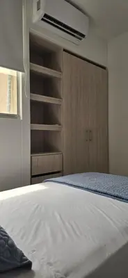 a bedroom with a white bed and a closet at SERENA REST Conjunto Capriella Cartagena in Manzanillo del Mar