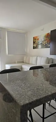 a living room with a couch and a table at SERENA REST Conjunto Capriella Cartagena in Manzanillo del Mar