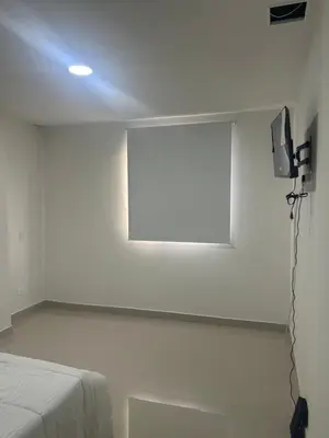 a white room with a tv and a bed at Aparta suite in Cartagena de Indias
