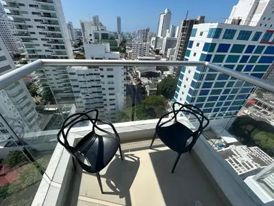 two metal objects on a balcony with a view of a city at APARTAMENTO MAGNO LOFT Bocagrande in Cartagena de Indias