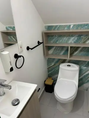 a bathroom with a toilet and a sink at APARTAMENTO MAGNO LOFT Bocagrande in Cartagena de Indias