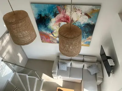 two baskets hanging from the ceiling in a living room at APARTAMENTO MAGNO LOFT Bocagrande in Cartagena de Indias