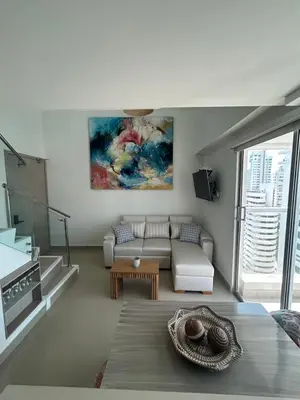 a living room with a couch and a table at APARTAMENTO MAGNO LOFT Bocagrande in Cartagena de Indias