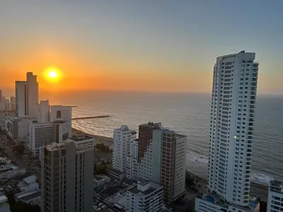 a sunset over the ocean in a city with tall buildings at APARTAMENTO MAGNO LOFT Bocagrande in Cartagena de Indias