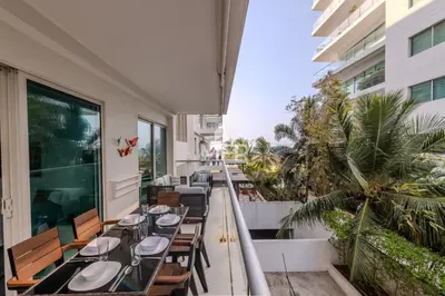 a balcony with tables and chairs on a building at Luxury beachfront Condo Edificio Morros 3 by Inmobiliaria MFR in Cartagena de Indias