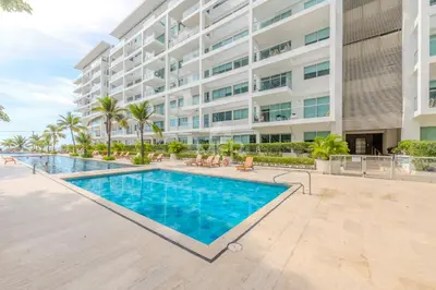 a swimming pool in front of a building at Luxury beachfront Condo Edificio Morros 3 by Inmobiliaria MFR in Cartagena de Indias