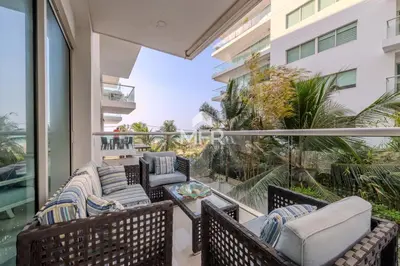 a balcony with chairs and a table on a building at Luxury beachfront Condo Edificio Morros 3 by Inmobiliaria MFR in Cartagena de Indias