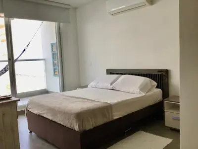 a bed in a room with a large window at Cartagena Colombia in Cartagena de Indias