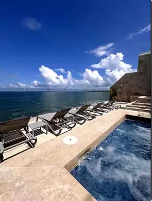 a pool with lounge chairs and a view of the ocean at Cartagena Colombia in Cartagena de Indias