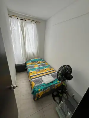 a small room with a bed and a fan at Apto en Alameda del rio cunjunto ruiseñor 1 piso 5 in Barranquilla