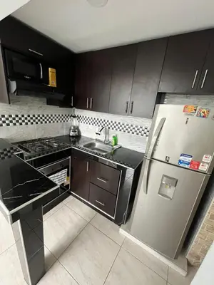 a kitchen with a stainless steel refrigerator and a sink at Apto en Alameda del rio cunjunto ruiseñor 1 piso 5 in Barranquilla