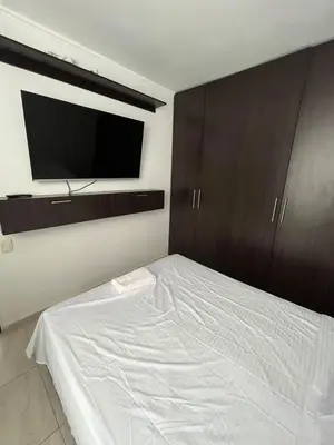 a bedroom with a bed and a flat screen tv at Apto en Alameda del rio cunjunto ruiseñor 1 piso 5 in Barranquilla