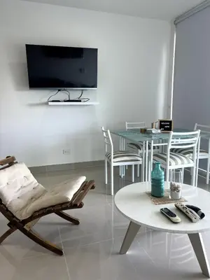 a living room with a tv and a table and chairs at Morros 922 Seaside Retreat in Cartagena de Indias