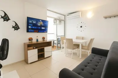 a living room with a table and a dining room at Apartamento Cartagena exclusive in Cartagena de Indias