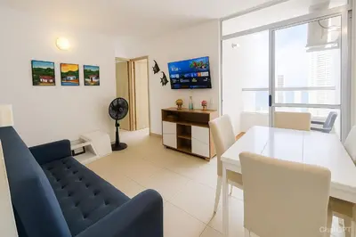 a living room with a blue couch and a table at Apartamento Cartagena exclusive in Cartagena de Indias