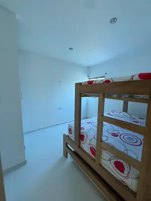 a wooden bed in a room with a blue light at Apartamentos Altos de Guayabal in El Triunfo