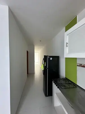 a kitchen with a black refrigerator in a room at Apartamentos Altos de Guayabal in El Triunfo