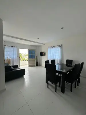 a living room with a dining room table and chairs at Apartamentos Altos de Guayabal in El Triunfo