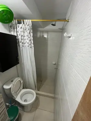 a small bathroom with a toilet and a shower at ruiseñor 1 in Barranquilla