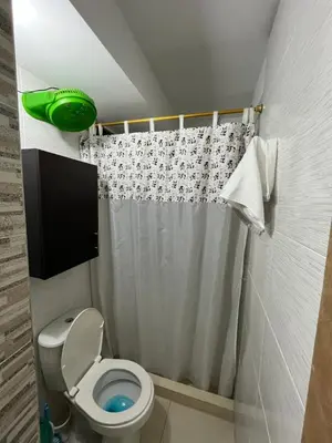 a bathroom with a toilet and a shower curtain at ruiseñor 1 in Barranquilla