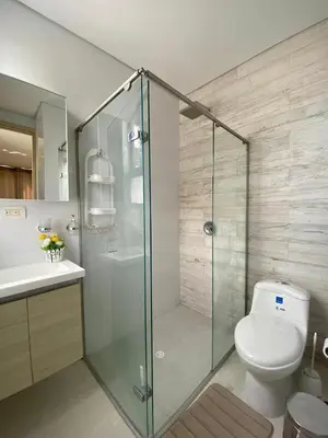 a bathroom with a toilet and a glass shower at 1 bedroom apartment close to the beach in Cartagena de Indias
