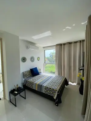 a bedroom with a bed and a large window at 1 bedroom apartment close to the beach in Cartagena de Indias