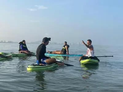 a group of people sitting on kayaks in the water at Ikako beach club in Cartagena de Indias